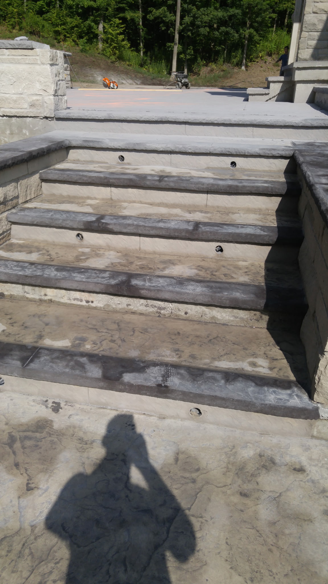Bare concrete stairs with unfinished light fixture holes, before installation